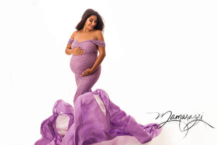 Studio maternity image in flowing aqua gown